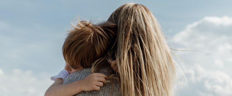 mother holding child outside