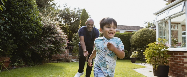 caregiver running outside with child